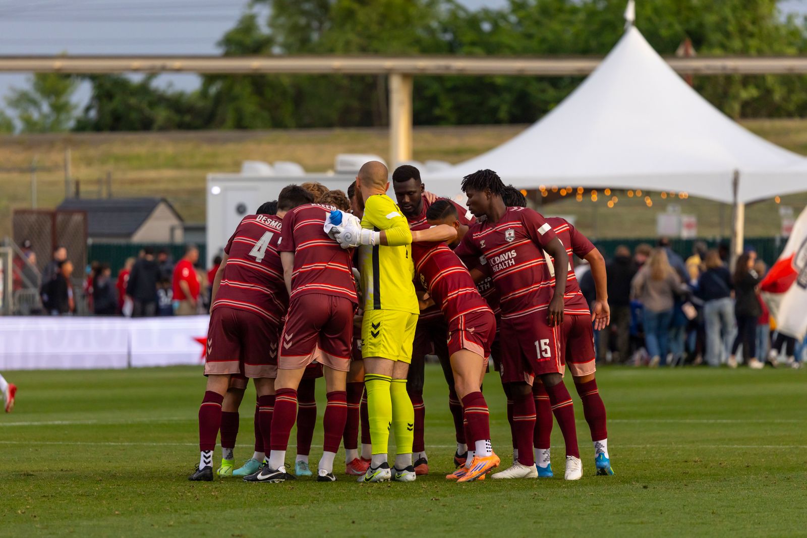 Soccer team huddling before a match