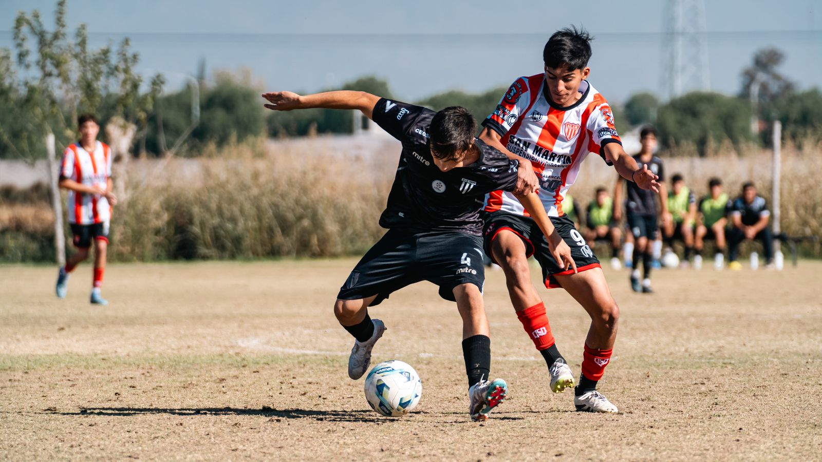 Youth soccer players competing for the ball in a match